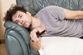 Lazy man with the remote on the couch Royalty Free Stock Photo