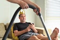 Lazy mature adult man behaving like a king using mobile phone