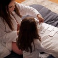 Lazy morning with Mom. a mother and daughter playing cards while sitting in bed. Royalty Free Stock Photo