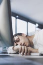 Lazy office worker sleeping at his desk Royalty Free Stock Photo