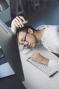 Lazy office worker sleeping at his desk Royalty Free Stock Photo