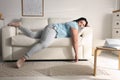 Lazy overweight woman resting on sofa