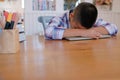 lazy stressed young little asian kid boy resting sleeping on de Royalty Free Stock Photo