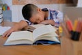 lazy stressed young little asian kid boy resting sleeping on de Royalty Free Stock Photo