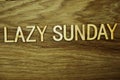 Lazy Sunday text message on wooden background Royalty Free Stock Photo