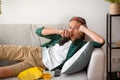 Lazy teenager laying on couch, eating junk food Royalty Free Stock Photo