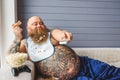 Lazy thick guy watching tv at home Royalty Free Stock Photo