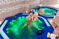 Lazy weekend for two - Couple relaxing in jacuzzi at health spa stock photo Royalty Free Stock Photo