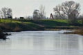 Lazy winding river with cows and trees on the riverbank