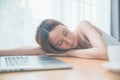 Lazy woman sleeping over a laptop in a desk Royalty Free Stock Photo