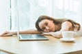 Lazy woman sleeping over a laptop in a desk Royalty Free Stock Photo