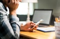 Lazy worker using phone in office avoiding work Royalty Free Stock Photo