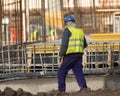Slacker is walking with cigarettes through the construction sit Royalty Free Stock Photo