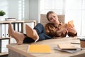 Lazy worker at wooden desk