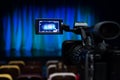 The LCD display on the camcorder. Shooting theatrical performances. The TV camera. Colorful chairs in the auditorium