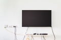 Lcd tv on wall with remote, wireless internet access point and s Royalty Free Stock Photo