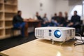 LCD video projector at business conference or lecture in a conference room or office with blurred people background Royalty Free Stock Photo