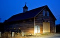 Ld barn with new siding at night/late dusk lit by car headlights Royalty Free Stock Photo