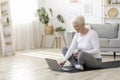 Lderly Woman Choosing Online Tutorials On Laptop For Training At Home