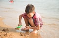 le boy playing sand on the beach summer time Royalty Free Stock Photo