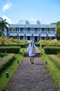 Le Chateau de Bel Ombre Mauritius, old castle in tropical garden in Mauritius, woman walking in a garden of an old