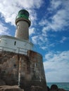 Lighthouse - view from the rocks below - on a bright sunny afternoon Royalty Free Stock Photo