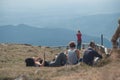 Tourists sitting on the top of mountain with panorama background Royalty Free Stock Photo