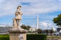 A statue of the king Francois I. Francis the first and pedestrian bridge in background