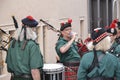 LE MANS, FRANCE - JUNE 13, 2014: Scottish bagpipe band is marching down the street during parade of pilots racing. Royalty Free Stock Photo