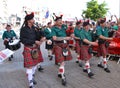 LE MANS, FRANCE - JUNE 13, 2014: Scottish bagpipe band is marching down the street during parade of pilots racing. Royalty Free Stock Photo