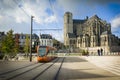 LE MANS, FRANCE - OCTOBER 08, 2017: Roman cathedral of Saint Julien with an orange tram at a Le mans, France