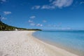 Le Morne beach Mauritius,Tropical beach with palm trees and white sand blue ocean and beach beds with umbrella,Sun