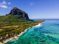 Le Morne beach Mauritius,Tropical beach with palm trees and white sand blue ocean and beach beds with umbrella,Sun