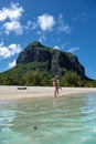Le Morne beach Mauritius,Tropical beach with palm trees and white sand blue ocean couple men and woman walking at the