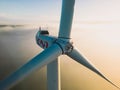 Le Pouzin, France - 2 Octobre, 2022: Close-up on the propellers of a wind turbine during a misty morning and sunrise. Royalty Free Stock Photo