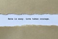 hate is easy love takes courage on white paper Royalty Free Stock Photo