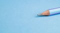 Lead of blue pencil. Sharpened simple pencil on a blue background. Sharpened pencil tip. Royalty Free Stock Photo