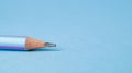 Lead of blue pencil. Sharpened simple pencil on a blue background. Sharpened pencil tip. Royalty Free Stock Photo