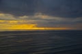 Lead clouds at sunset over the sea.