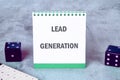 Lead generation notebook with dice on a gray surface, showcasing a creative workspace for marketing professionals Royalty Free Stock Photo
