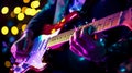 A lead guitarist's fingers moving across the fretboard, creating magic at a birthday party