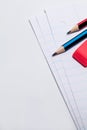 Two pencils and an eraser on lined paper closeup Royalty Free Stock Photo