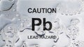 Lead Poisoning of drinking water is shown using the text on metal background Royalty Free Stock Photo