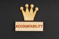 On a black surface there is a wooden crown and a block with the inscription - Accountability Royalty Free Stock Photo