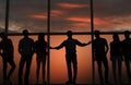 Leader and a group of young people standing near a large window Royalty Free Stock Photo