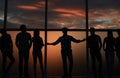 Leader and a group of young people standing near a large window Royalty Free Stock Photo