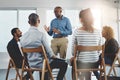 Leader, manager or boss talking to and teaching his team of employees and colleagues in a meeting, seminar or workshop Royalty Free Stock Photo