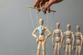 Leader puppet activist and workers. Concept of how to manage leader in team. Doll in tie on the ropes controlled by hand