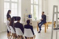 Leader of the startup team listens to suggestions from his colleagues at a meeting the office. Royalty Free Stock Photo