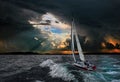 A sailboat in the stormy sea.Black background.